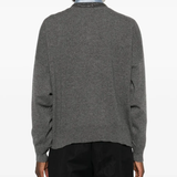 Grey knitwears worn by a person, showing the knitwears fit