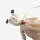 Close up of white doll, showing texture of the wool and cotton and linen fabric