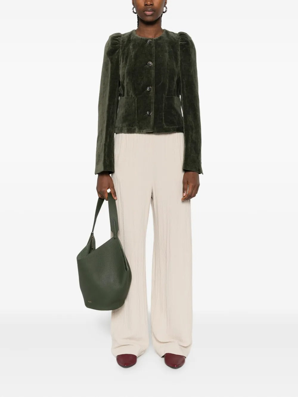 Green jacket worn by a person, showing the jacket’s fit