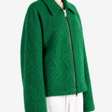 Green jacket worn by a person, showing the jacket fit