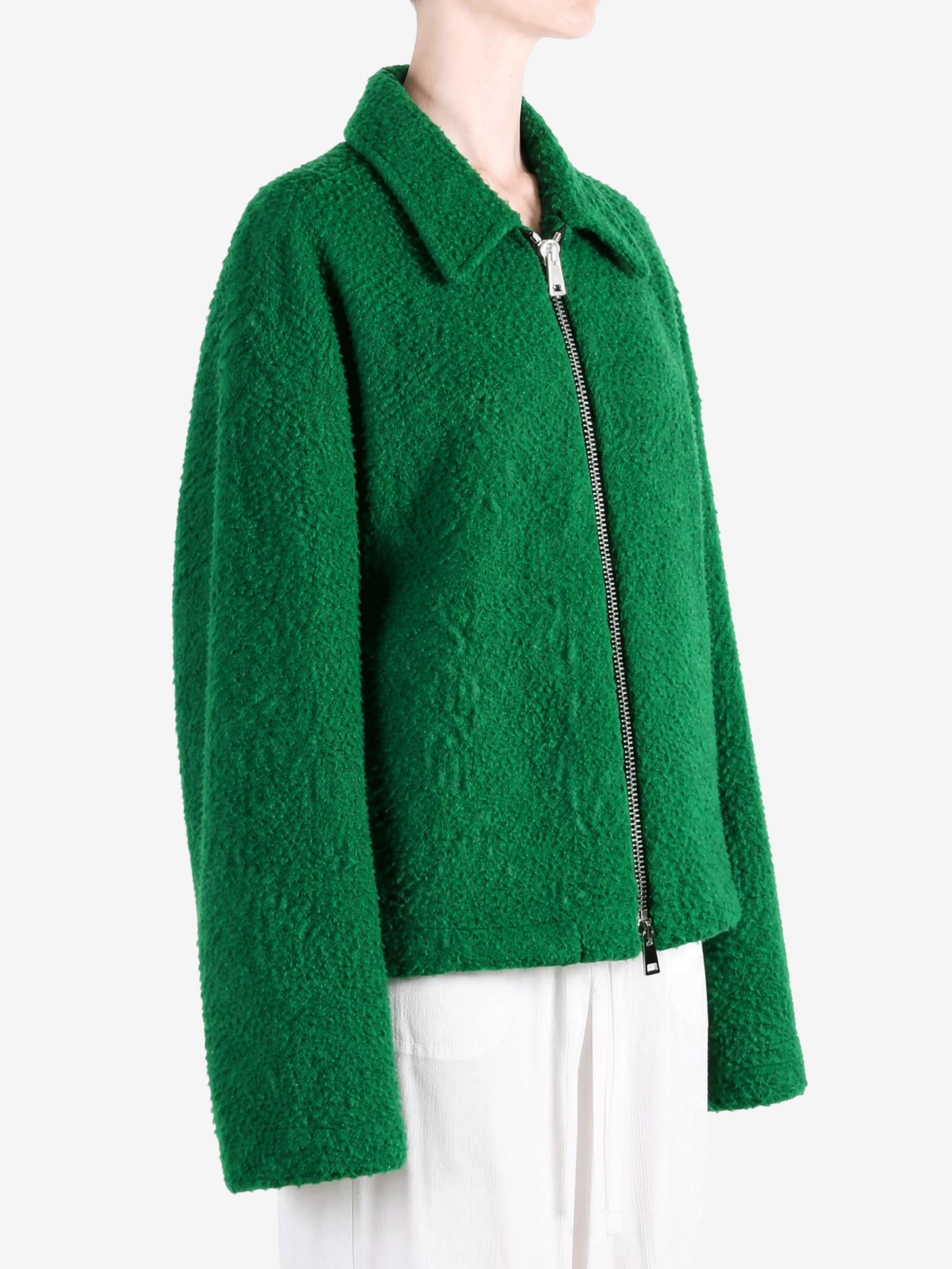 Green jacket worn by a person, showing the jacket fit