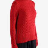 Red knitwear worn by a person, showing the knitwear's fit