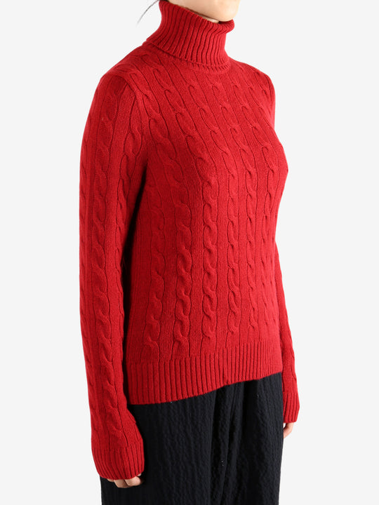 Red knitwear worn by a person, showing the knitwear's fit