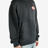 Black hoodie worn by a person, showing the hoodie’s fit