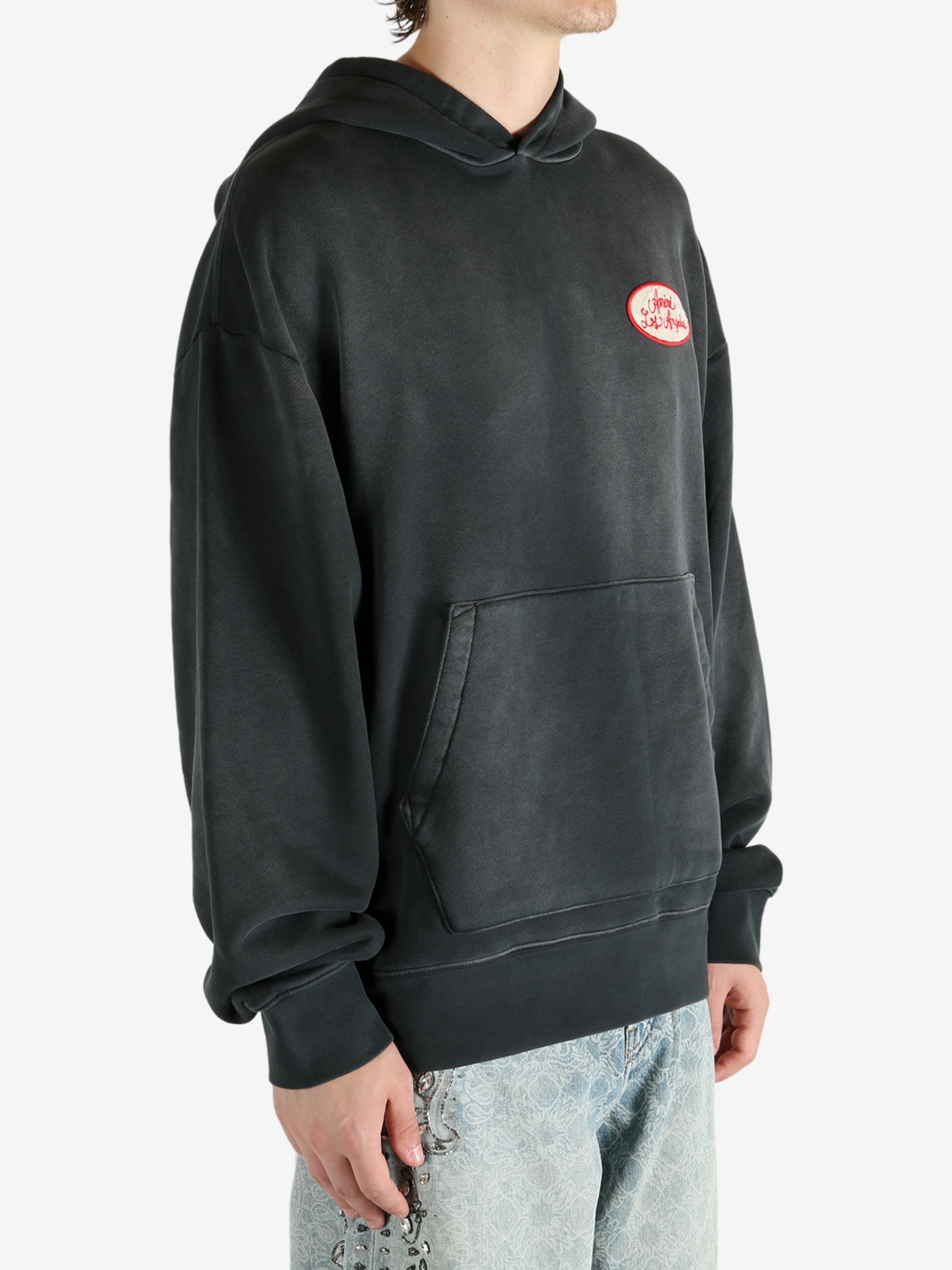 Black hoodie worn by a person, showing the hoodie’s fit