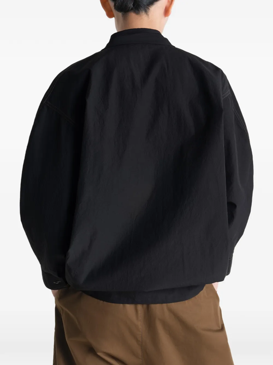 Black top worn by a person, showing the top's fit