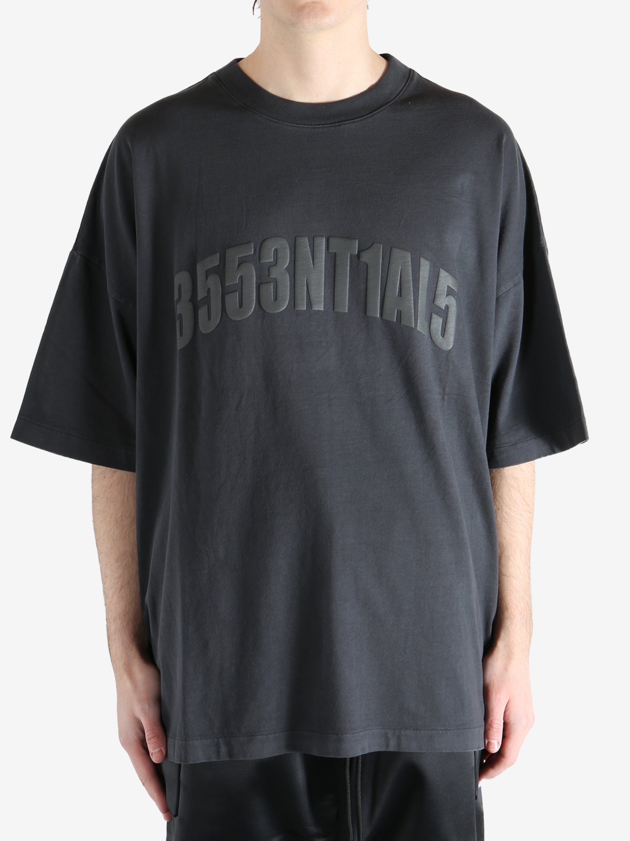 Black t-shirt worn by a person, showing the shirt's fit