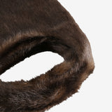 Close up of the brown bag, showing texture of the leather fabric