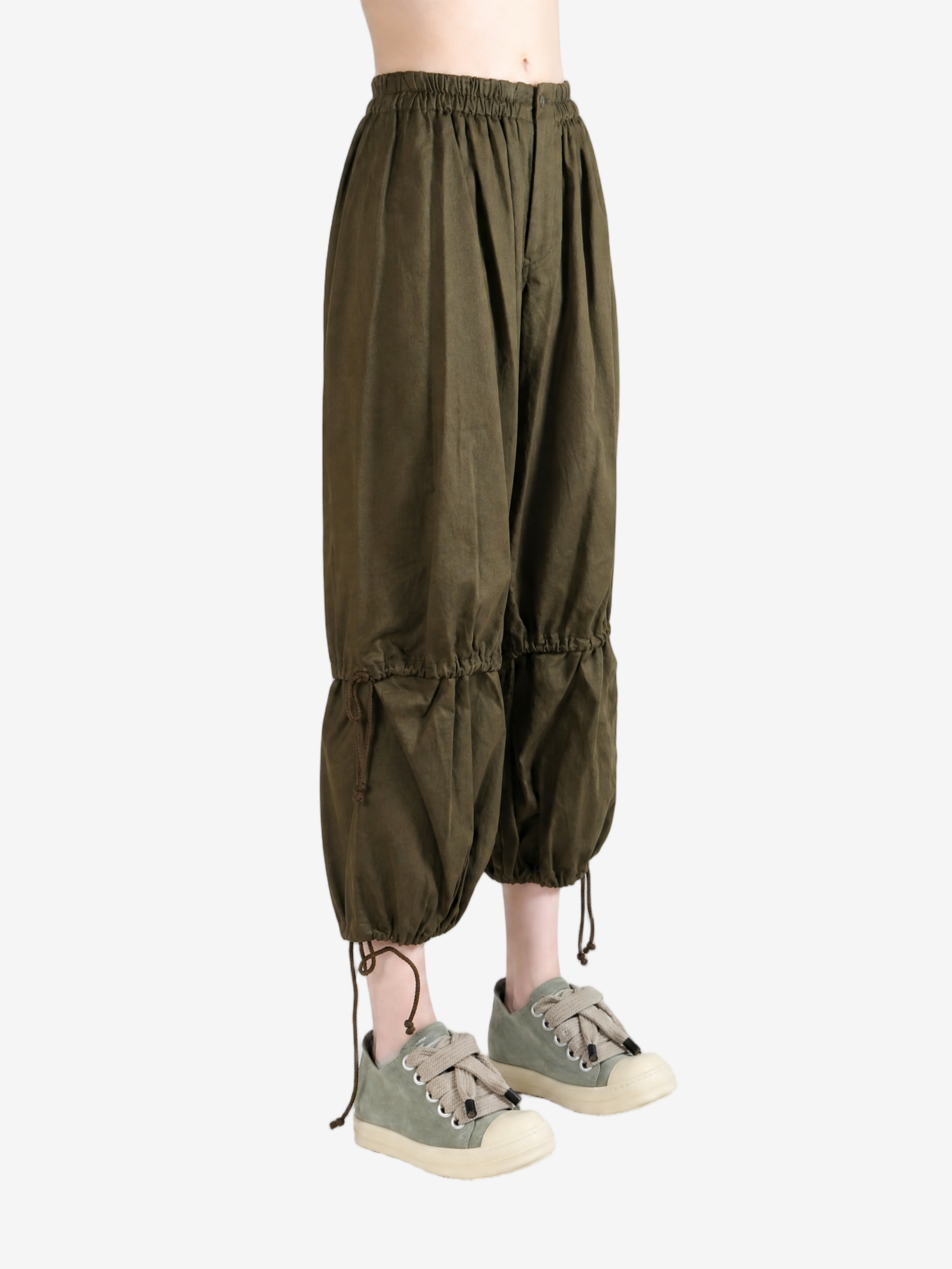 Green pants worn by a person, showing the pants fit