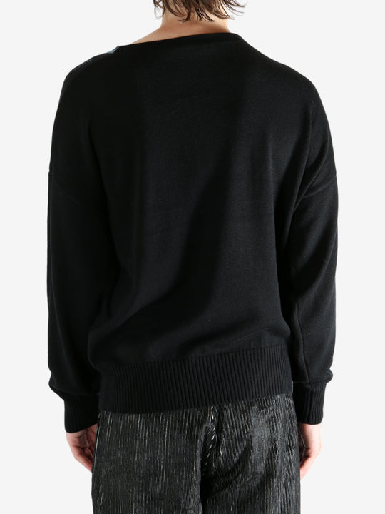 Black top worn by a person, showing the top's fit