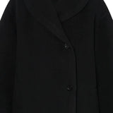 Close up of the black coat, showing texture of the wool fabric