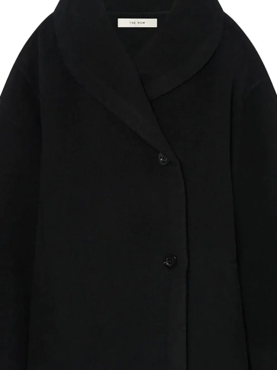 Close up of the black coat, showing texture of the wool fabric