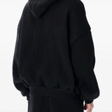Black hoodie worn by a person, showing the hoodie's fit