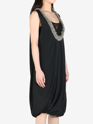 Black dress worn by a person, showing the dress's fit