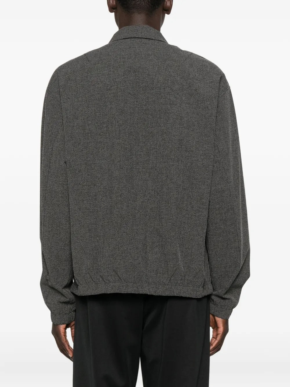 Black shirts worn by a person, showing the shirts fit