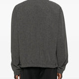 Black shirts worn by a person, showing the shirts fit