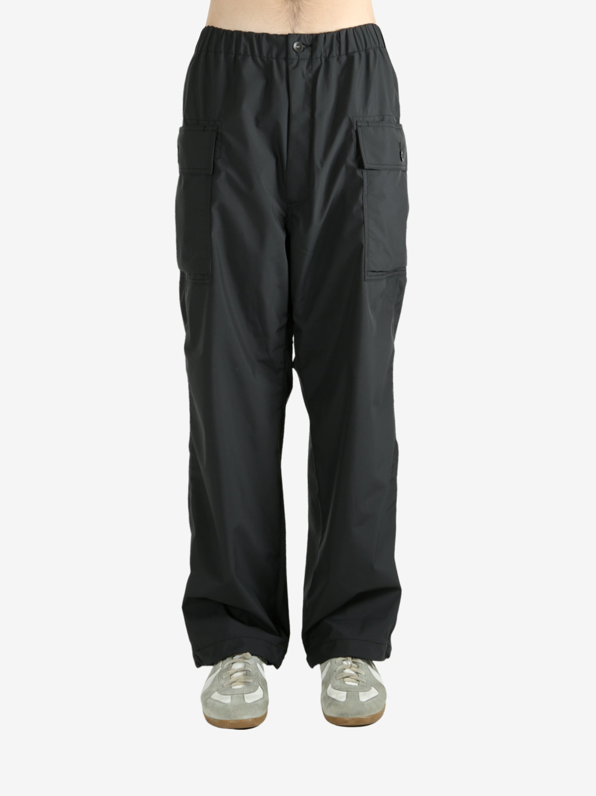 Black pants worn by a person, showing the pants's fit