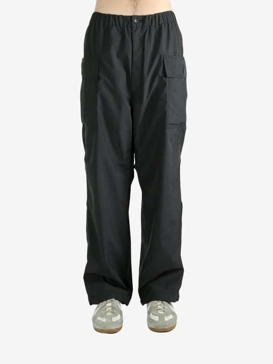 Black pants worn by a person, showing the pants's fit