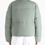 Green jacket worn by a person, showing the jacket fit