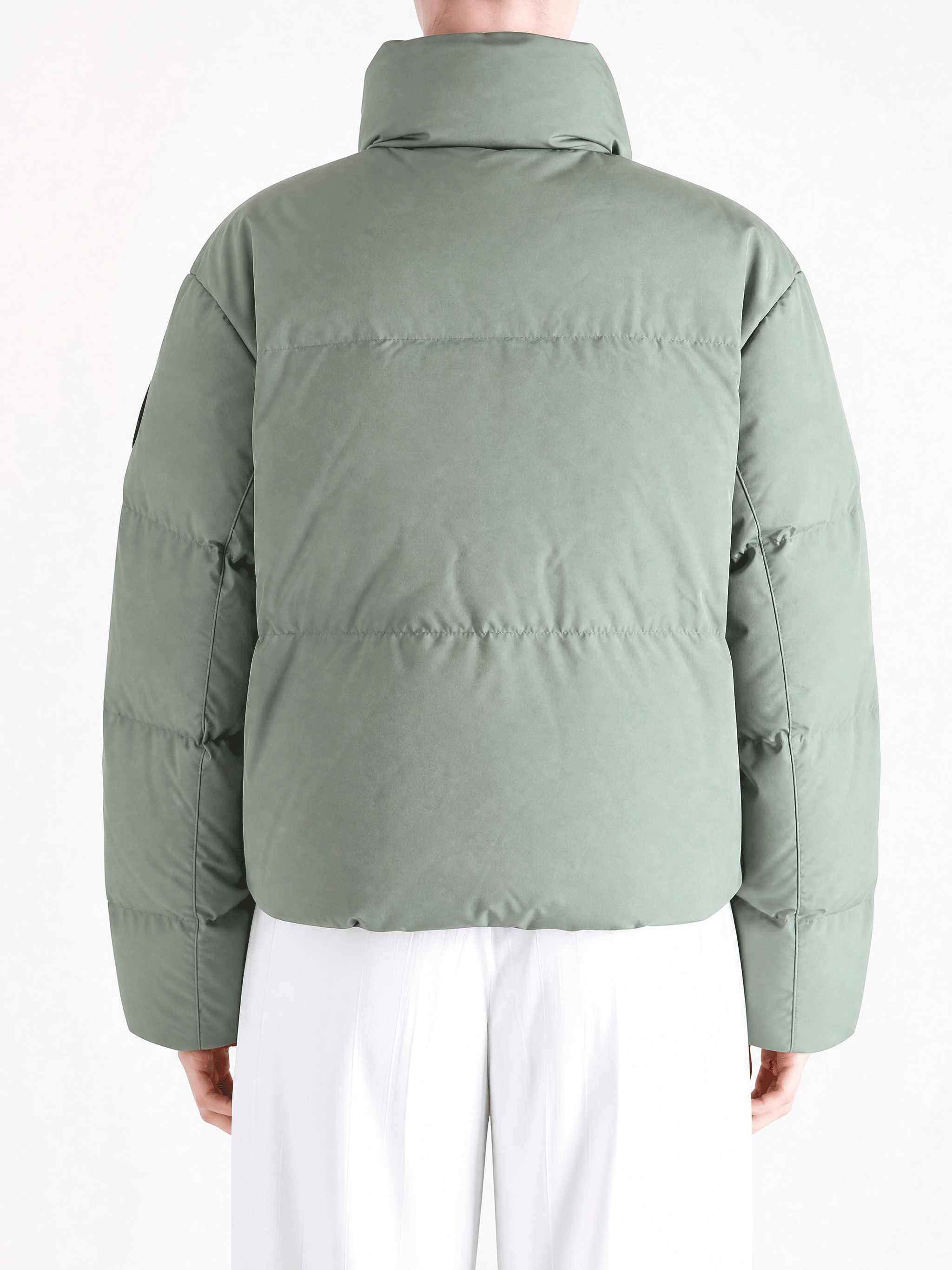 Green jacket worn by a person, showing the jacket fit