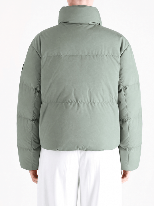Green jacket worn by a person, showing the jacket fit