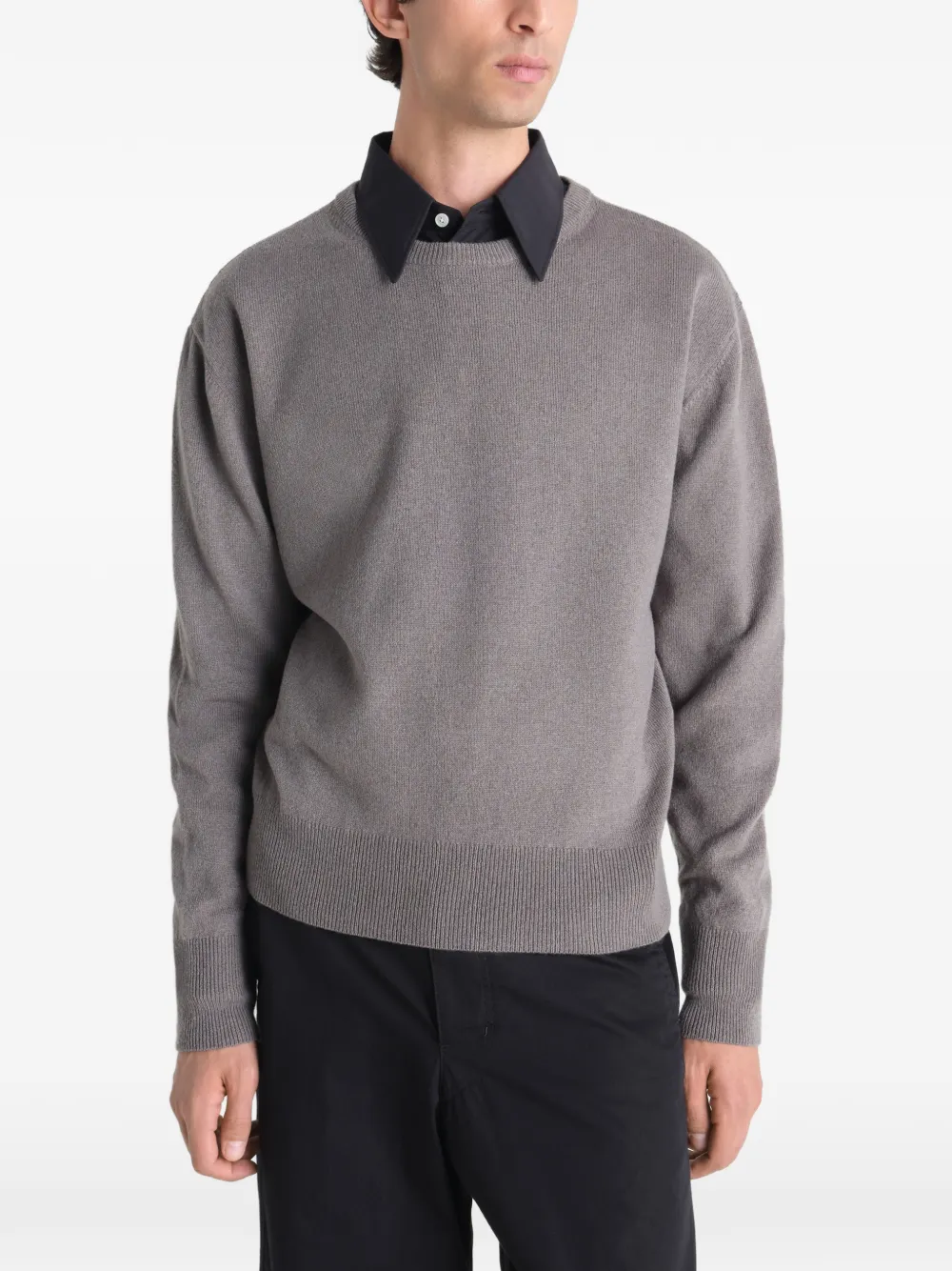 Grey sweater worn by a person, showing the sweater fit