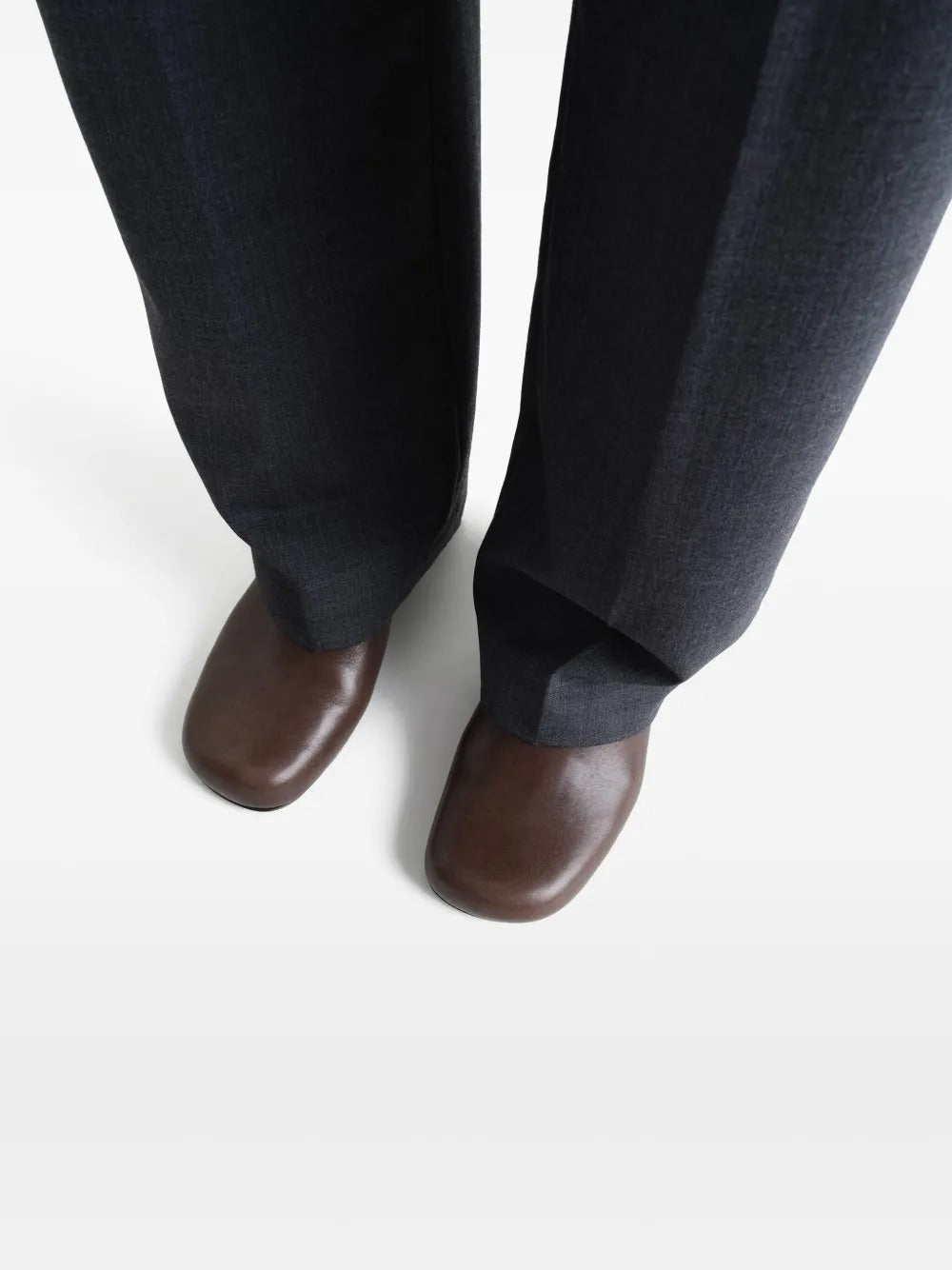 Brown heels worn by a person, showing the heels' fit