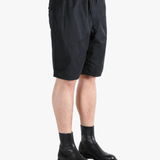 Black short worn by a person, showing the short's fit