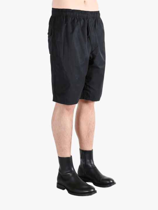 Black short worn by a person, showing the short's fit
