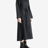 Black dresses worn by a person, showing the dresses fit