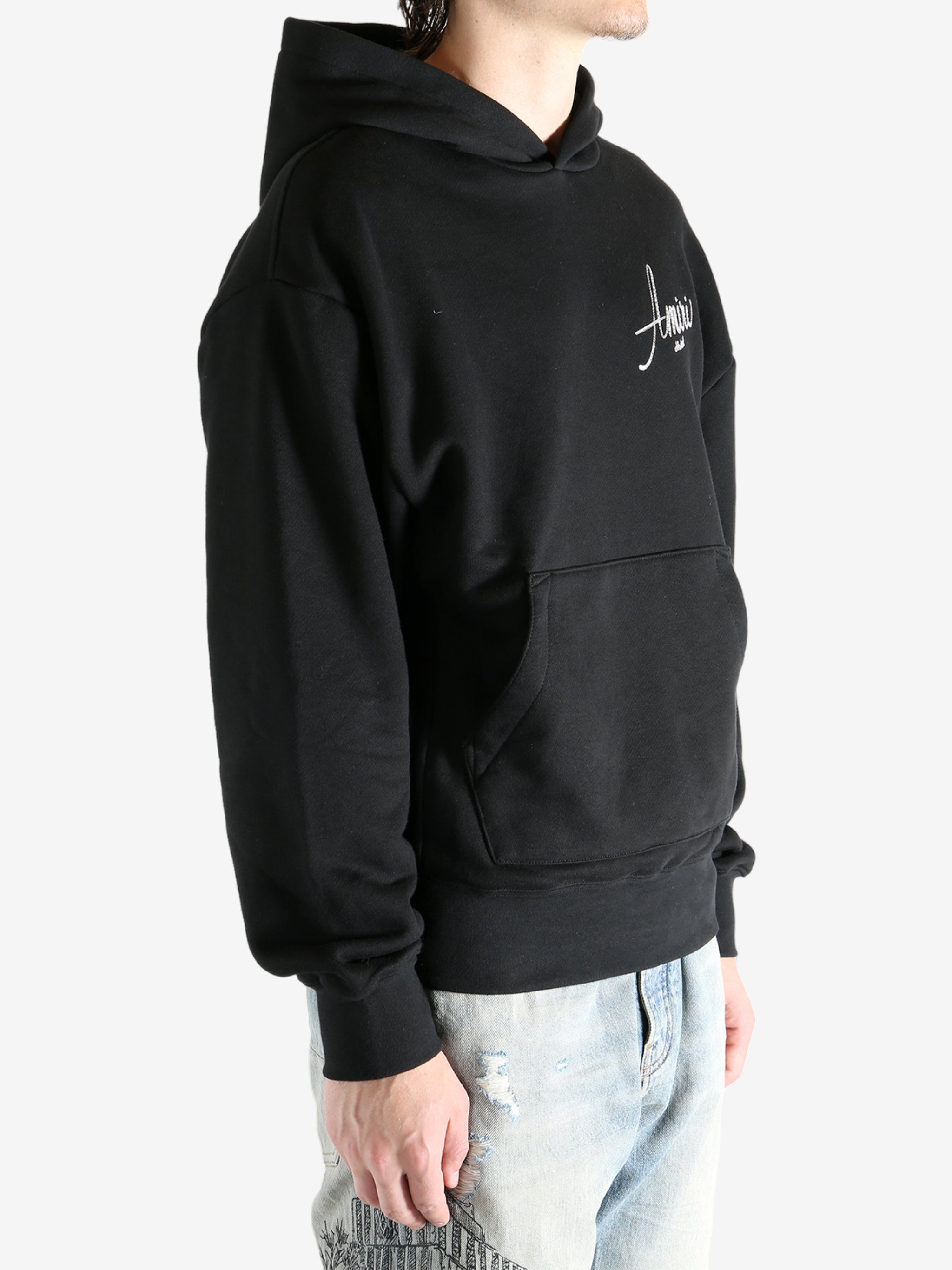 Black hoodie worn by a person, showing the hoodie fit