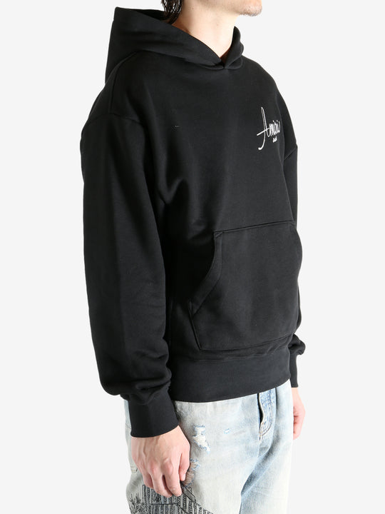 Black hoodie worn by a person, showing the hoodie fit