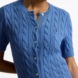Blue knitwear worn by a person, showing the knitwear fit