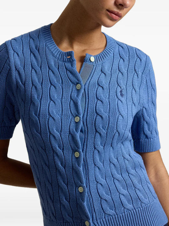 Blue knitwear worn by a person, showing the knitwear fit