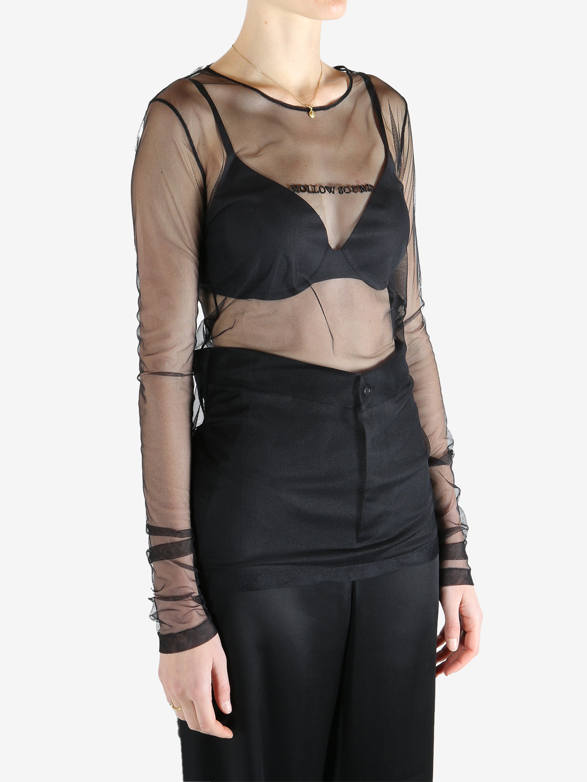 Black top worn by a person, showing the top's fit