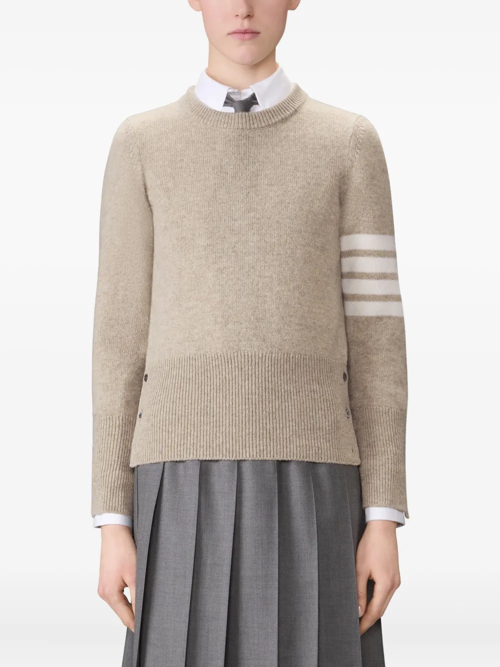 tan knitwear worn by a person, showing the knitwear fit