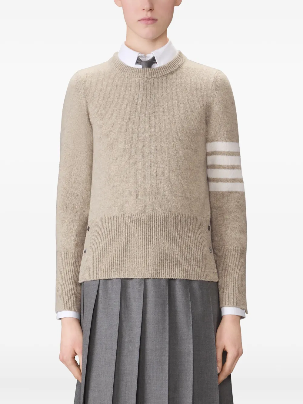 tan knitwear worn by a person, showing the knitwear fit