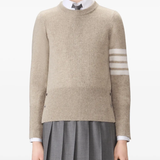 tan knitwear worn by a person, showing the knitwear fit