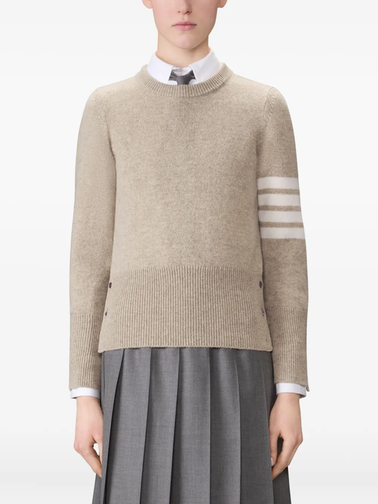 tan knitwear worn by a person, showing the knitwear fit