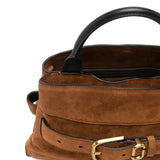 Close up of brown bags, showing texture of the suede cow leather fabric