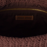 Close up of brown bag, showing the detial of inside pocket and logo patch