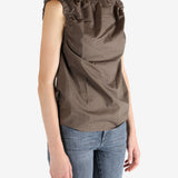 Brown top worn by a person, showing the top fit