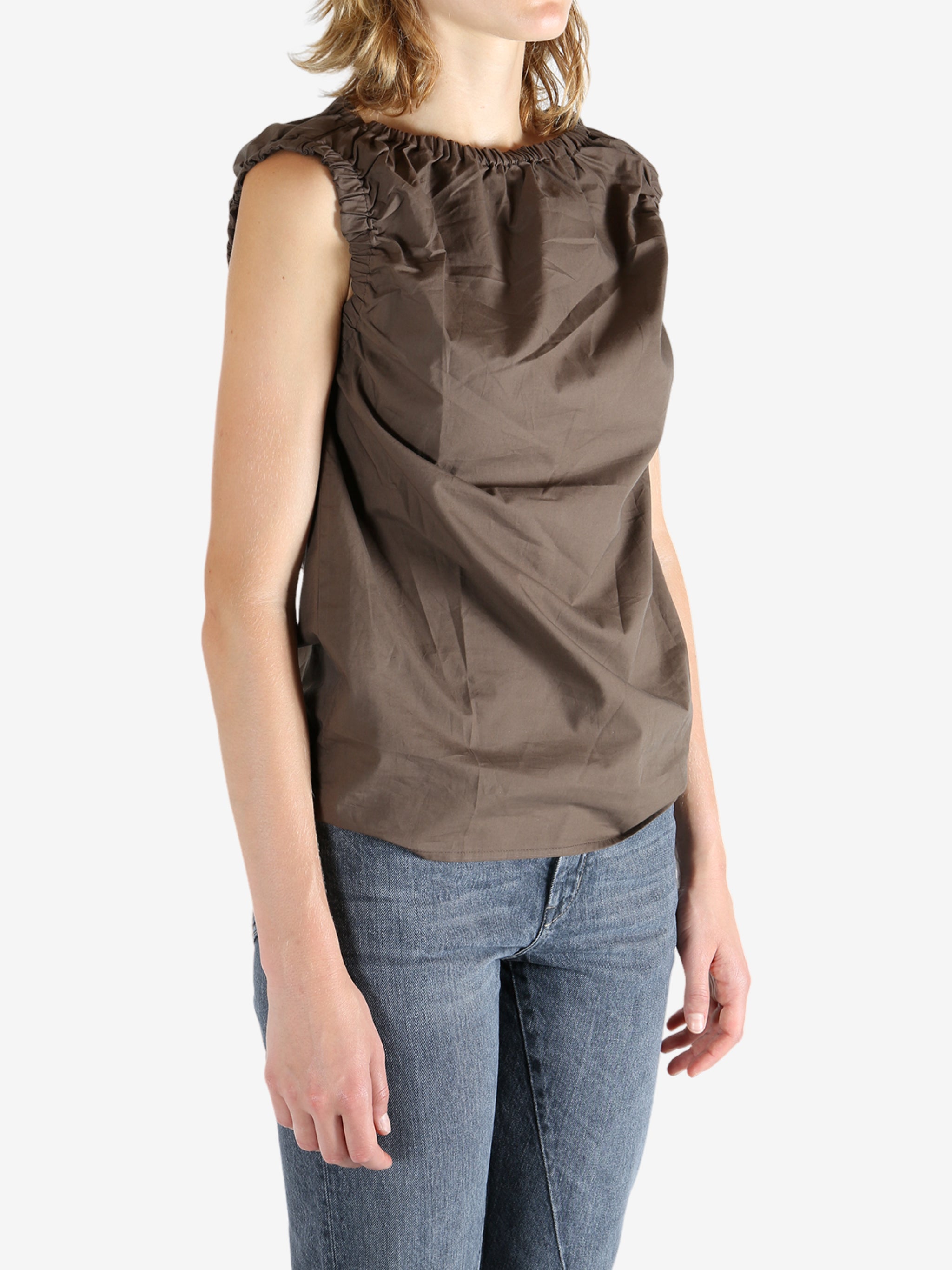 Brown top worn by a person, showing the top fit