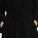 Black jacket worn by a person, showing the jacket fit