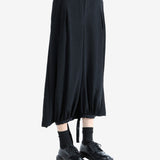 Black pants worn by a person, showing the pants' fit