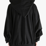 black sweats-hoodies worn by a person, showing the sweats-hoodies  fit