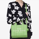 Green bags worn by a person, showing the bags fit