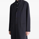 Black coats worn by a person, showing the coats fit