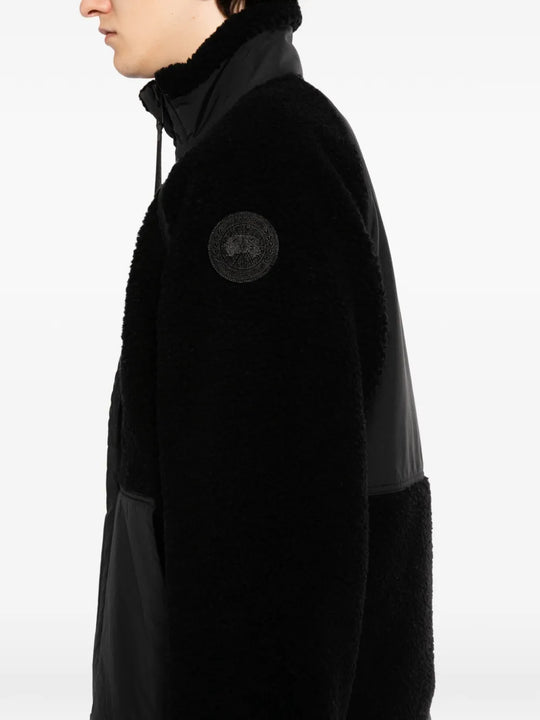 Black jacket worn by a person, showing the jacket fit