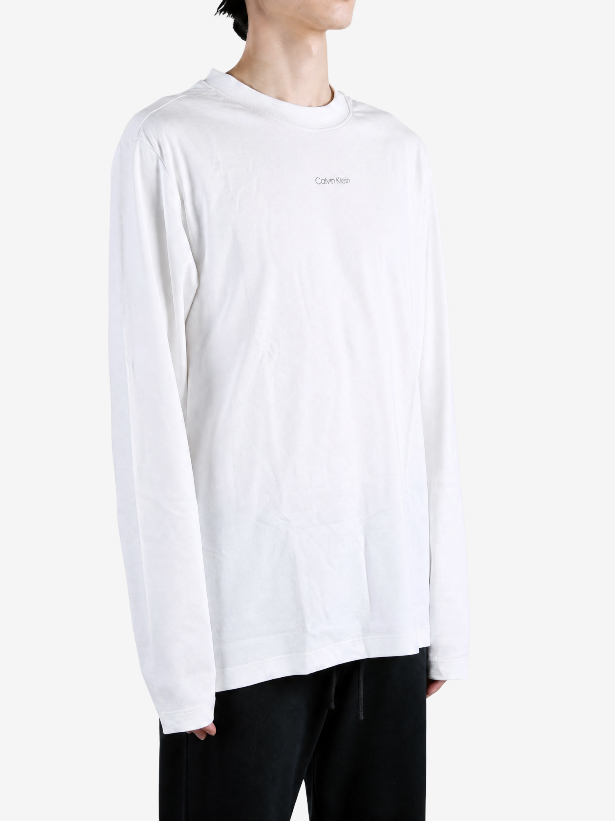 White t-shirt worn by a person, showing the t-shirt fit